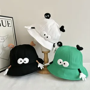 Funny cartoon bucket hat with 3D eyes and arms for sun protection in white, black and green