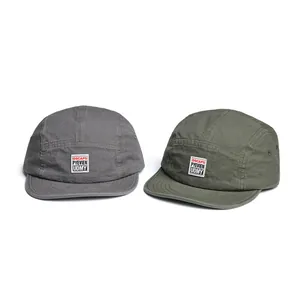 Vintage style baseball caps in dark grey and olive green with embroidered patch labels