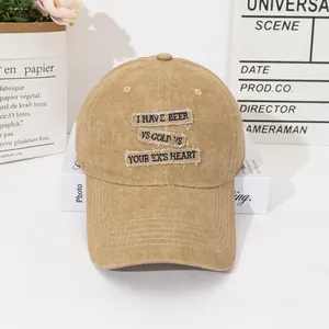 Detailed close-up of khaki washed cotton baseball cap with vintage embroidered patches
