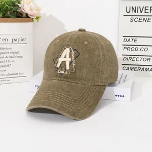 Close-up of vintage washed cotton baseball cap with letter A embroidery and reinforced brim