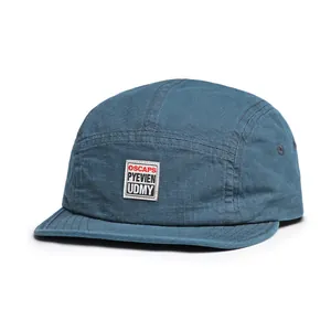 Close-up of 5-panel gray-blue ripstop camper hat featuring white woven logo patch
