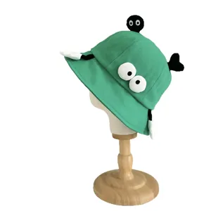 Green canvas cartoon bucket hat with soot sprites and eye details for sun protection