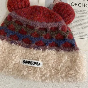 Detailed macro view of plush teddy bear ear knit hat with colorful diamond pattern and fleece