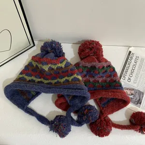 Cozy Fair Isle knit earmuff hats for women with large pom-poms and warm ear flaps