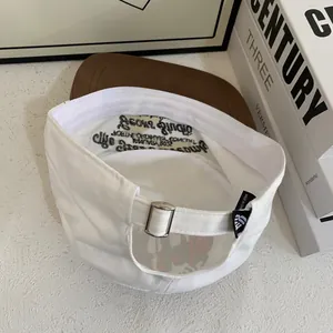 Detailed view of two-tone baseball cap with adjustable metal buckle and inner embroidery
