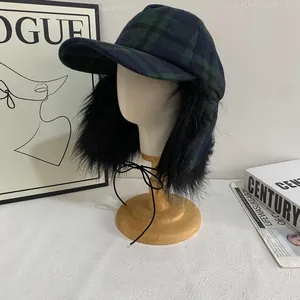 Detail of plaid wool bomber hat featuring thick faux fur earflaps and tie strings