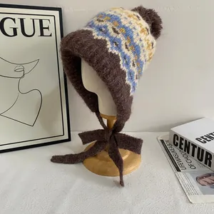 Fair Isle knit trapper hat with pom-poms and warm earflaps in vintage brown and blue