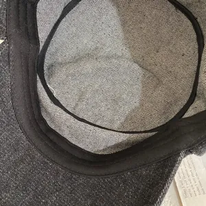 Detail of internal black sweatband and twill fabric texture of the vintage flat cap
