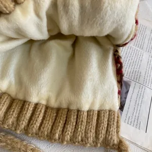 Detail shot of warm brown knit exterior and thick cream faux fur lining for winter protection