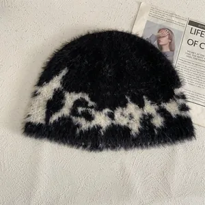 Detailstruktur der schwarzen Plüsch-Strickmütze mit weißen Mustern und flauschigem Mohair-Gefühl