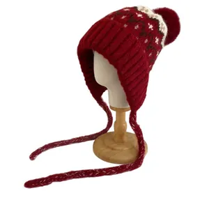 Winter Fair Isle knit trapper hat with pom-pom and braided ties in festive red and white