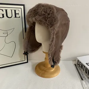 Detail of winter aviator hat featuring deep brown PU leather and plush faux fur lining