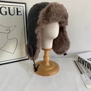 Detail einer warmen Uschanka mit dickem braunem Kunstfellfutter und schwarzem Leder