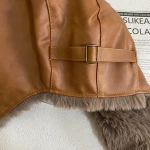 Close-up of brown PU leather aviator hat showing metal buckle and plush lining