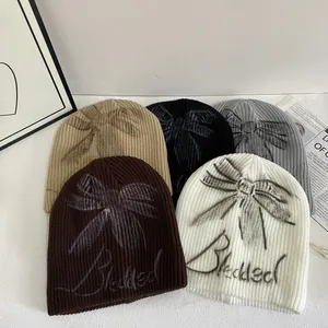 Trendy Women Knit Beanie Hat With Bow Knot Graffiti Letter Print Winter Warm Ribbed Skull Cap Streetwear Casual Headwear