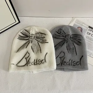 Beanie set in cream and grey featuring black butterfly graphic and Blessed lettering
