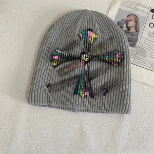 Chic grey knit beanie with colorful graffiti cross pattern for a street style look