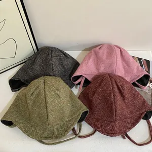 Herringbone winter trapper hats in four colors with earflaps and woven chin straps