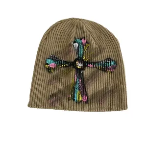 Knitted beanie with graffiti cross print in khaki street style for autumn and winter