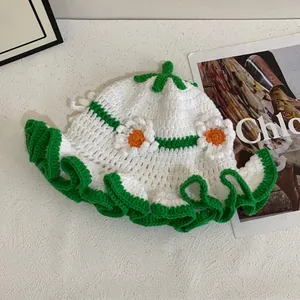 Handmade crochet bucket hat with floral knit patterns and green scalloped brim for women