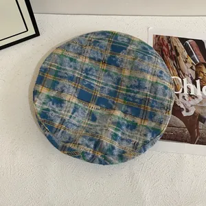 Close-up detail of vintage plaid tweed fabric in blue and yellow on this beret hat