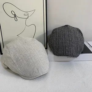 Chic herringbone beret hat in dark and light grey with subtle metallic glitter detail