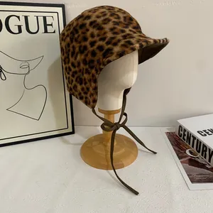 Detail view of winter leopard print aviator hat with plush faux fur and ear flaps