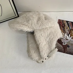 Detailopname van de crèmekleurige pluche pilotenmuts met verstelbare kinriem voor winter