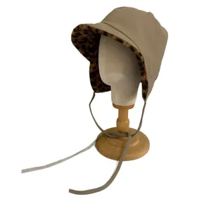 Winter khaki trapper hat with leopard print faux fur lining and earflaps for thermal warmth