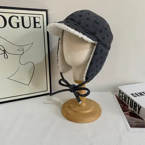 Close-up of winter aviator hat with grey polka dots and soft faux lamb wool lining