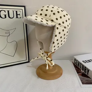 Close-up of winter pilot hat with brown polka dots and white faux lamb wool lining