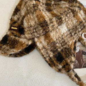 Gros plan d'un bonnet aviateur en peluche léopard avec étiquette de marque en cuir