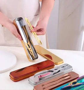 Detail of multi-color 304 stainless steel crab tools set with storage boxes on table