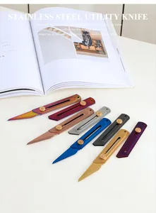 Colorful stainless steel utility knives in diverse finishes on a white desk setting