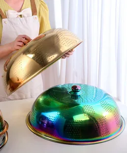 Macro detail of stainless steel food covers showing gold and rainbow mesh and top handle