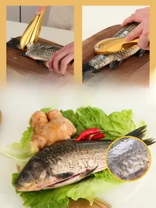 Macro shot of stainless steel fish scaler removing scales on a wooden cutting board