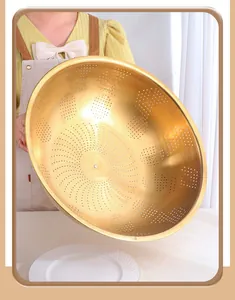 Close-up of golden stainless steel colander with precision drainage holes and deep design