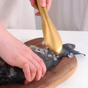 Golden stainless steel fish scaler with double-row serrated teeth for kitchen use