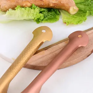 Stainless steel fish scaler in gold and rose gold with anti-slip handle and hanging hole