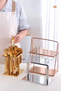 Macro shot of stainless steel cutlery rack with gold and silver forks and spoons