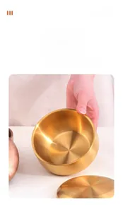 Detail showing high-grade golden stainless steel bowl with brushed texture and smooth edge