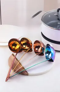 Detail view of colorful 304 stainless steel oil filter spoons with long handles and hang holes