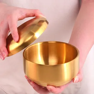 Golden double-walled stainless steel bowl with lid featuring a brushed metallic finish