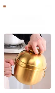Detail of golden stainless steel lunch box showing leak-proof spiral locking lid mechanism