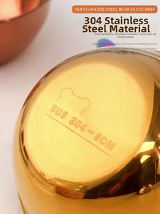 Macro detail of golden 304 stainless steel sauce dish with engraved bear logo and 8cm size