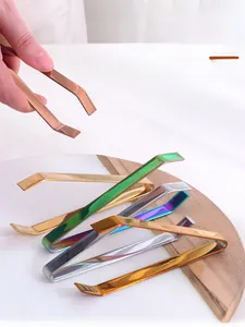 Macro detail of 304 stainless steel food tweezers in gold and silver finishes