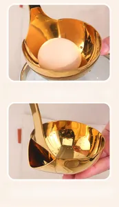 Detail of deep golden stainless steel soup ladle bowl with specialized side pouring spout