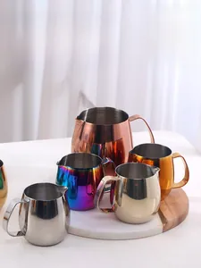 304 stainless steel milk frothing pitchers in various colors on a marble tray