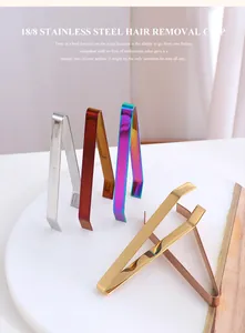 Detailed macro view of four colorful 304 stainless steel kitchen tweezers on a marble tray