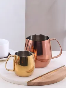Close-up of 300ml and 700ml stainless steel frothing pitchers in gold and rose gold